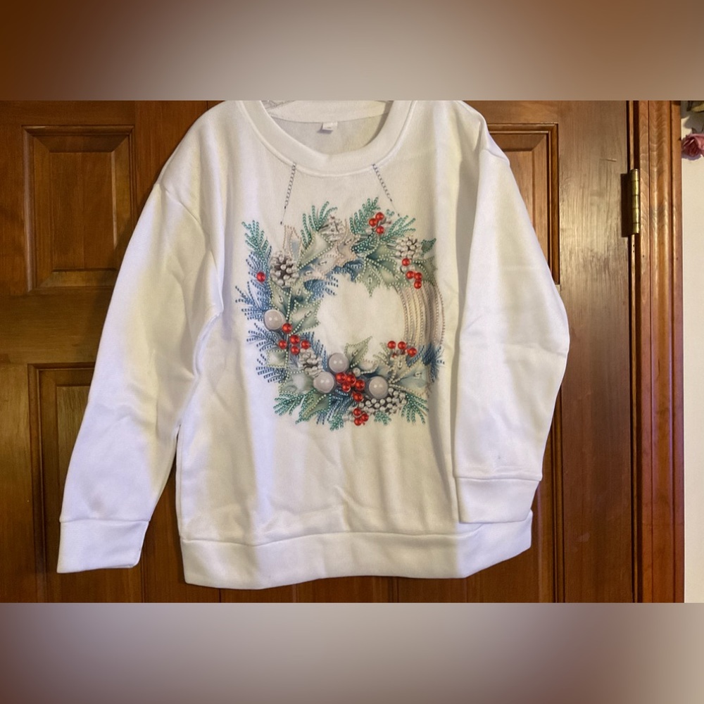 New sweatshirt with a holiday wreath on front.  Brand new, never worn, size XL